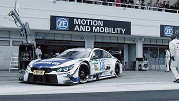 BMW DTM touring car in front of the ZF Motorsport pit lane